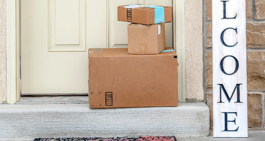 Boxes by the door of a residence with a welcome sign in Montgomery